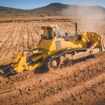 Aerial image of a bulldozer pushing and ripping ground on an agr